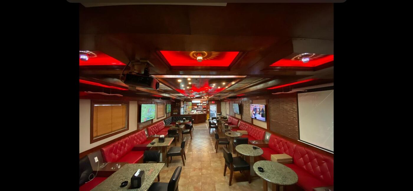 Babylon Hookah Lounge dining area with red lighting