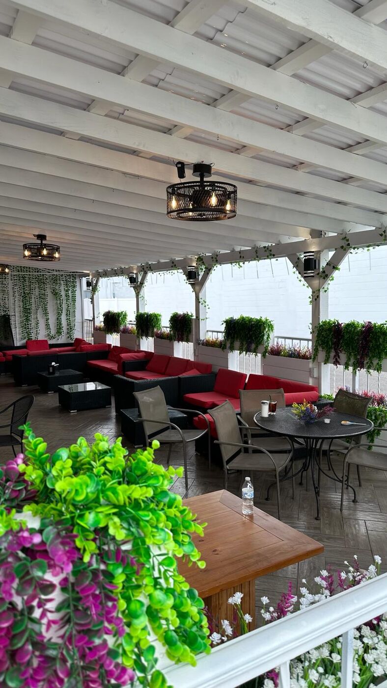 Babylon Hookah Lounge patio with greenery and seating